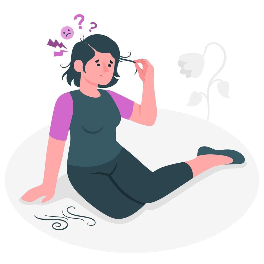 Imagem de uma mulher sentada no chão de camiseta rosa e cinza passando a mão nos cabelos, e ao chão os cabelos caídos devido a tricotilomania